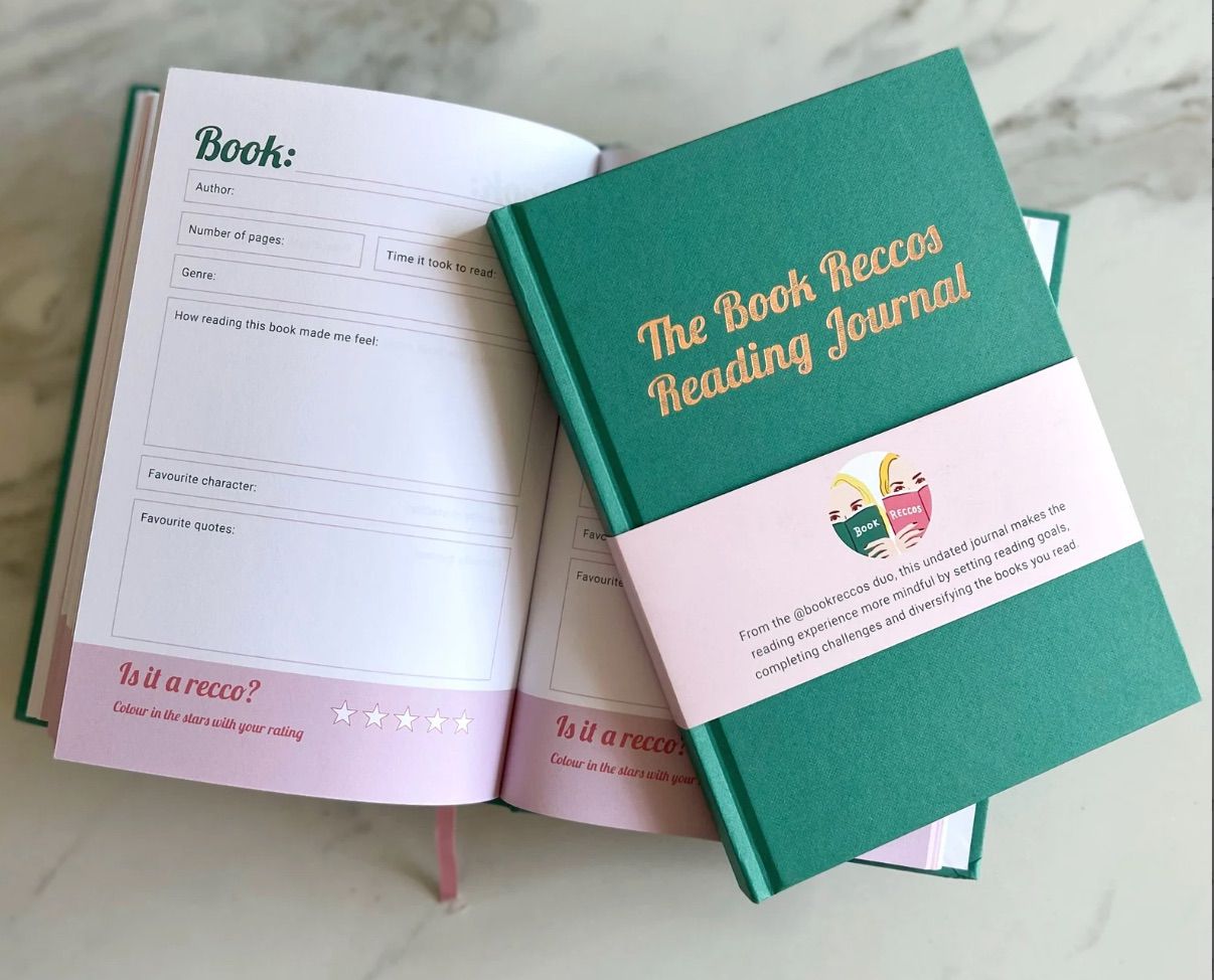 Image of a set of book recommendation journals. They have a green cover and pink interior.