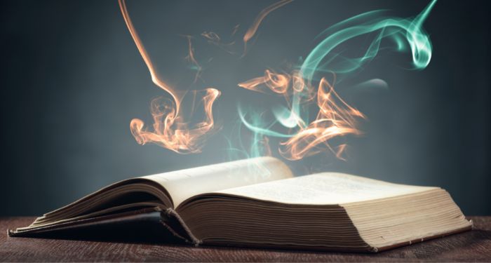 Image of an open book with colorful sparks coming from it