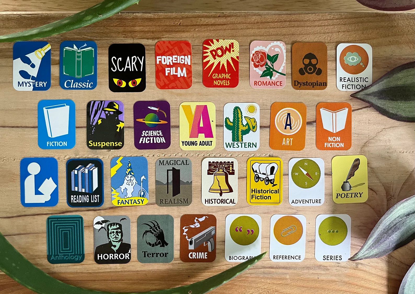 stickers naming literary genres with thematic illustrations