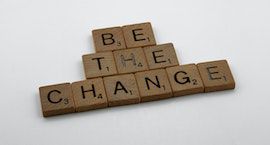 the words BE THE CHANGE created by Scrabble letters